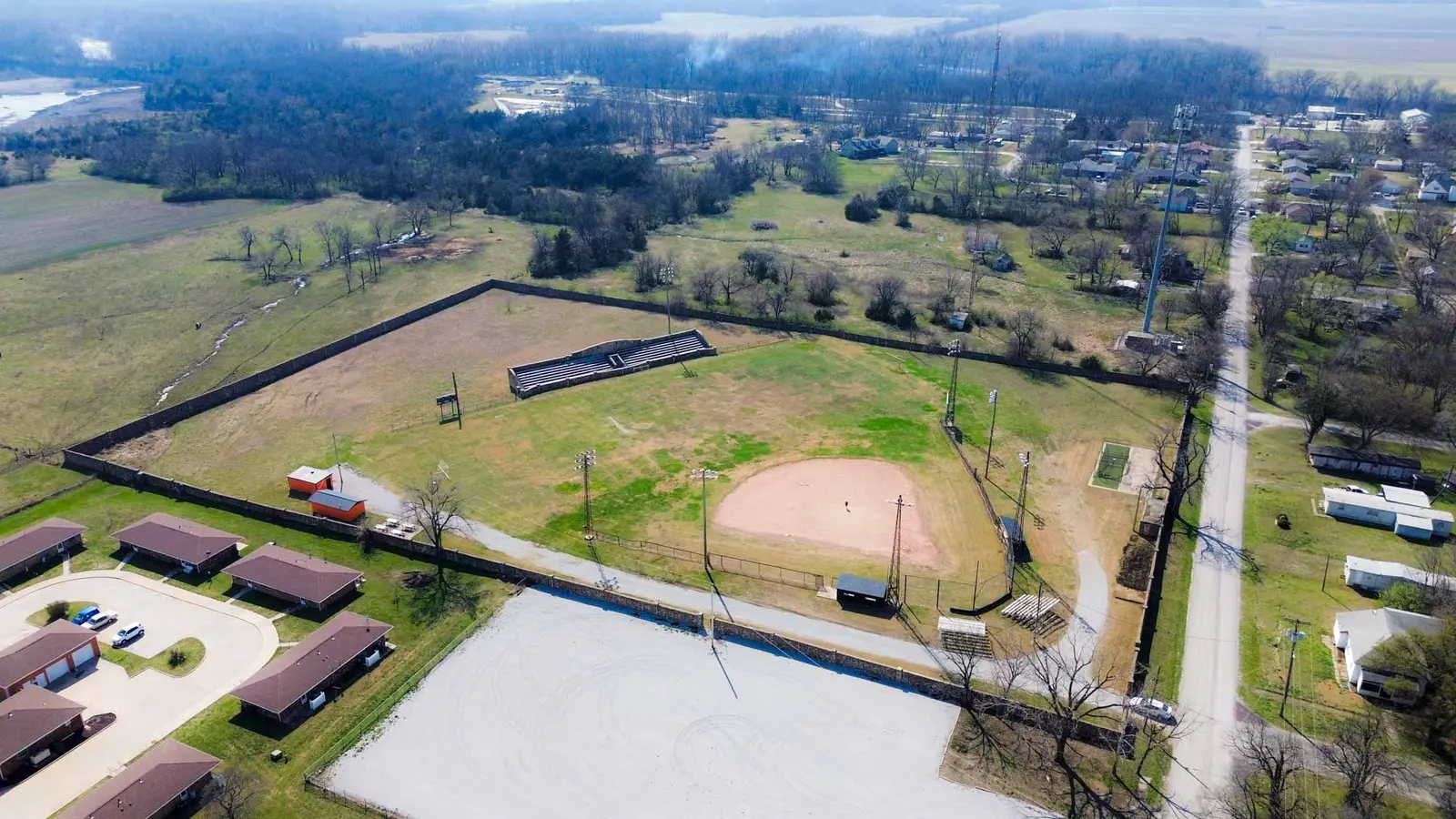 High aerial overview of the ballfield complex, adjacent fields, and surrounding neighborhood.